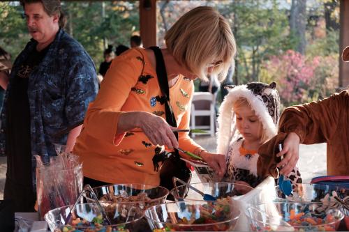 Children in Halloween costumes select candy at a trick-or-treating station during Spooktacular at Anderson Japanese Gardens in Rockford, Illinois.