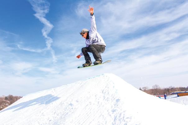 Showboarder on a jump at Snow Park at Alpine Hills