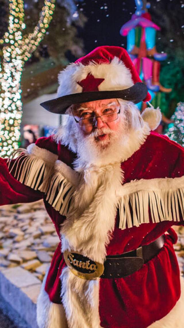 Santa in front of holiday outdoor decorations at SeaWorld San Antonio.