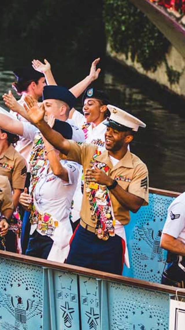 Service men and woman waving on river barge