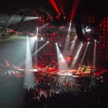 Inside arena with spotlights over crowd in the Alamodome.