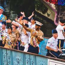 Service men and woman waving on river barge
