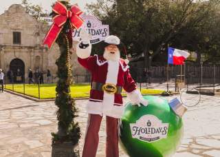 Santa standing in front of the Alamo