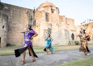 Performer smiling at San Antonio Missions National Historical Park.