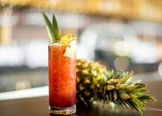 Adult beverage next to a pineapple