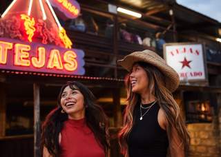 Two girls laughing at Tejas Rodeo in San Antonio
