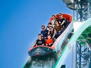 Family on rollercoaster on downward slope