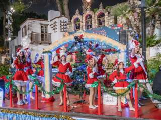 Girls dressed in Santa costumes on river barge
