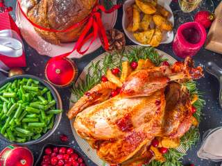 Holiday turkey dinner surrounded by sides