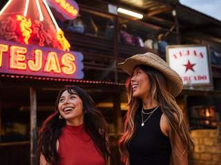 Two girls laughing at Tejas Rodeo in San Antonio