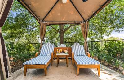 Two lounge chairs under a covered area