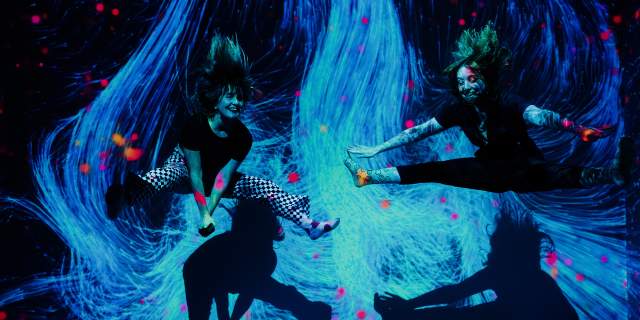 Two girls jumping in interactive museum