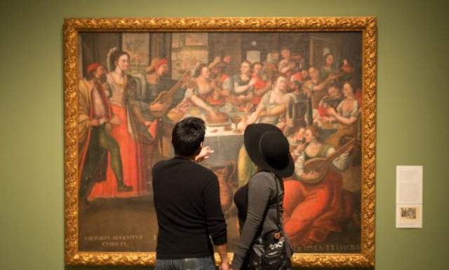 Man and woman looking at painting