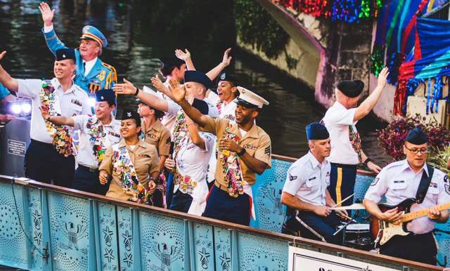 Service men and woman waving on river barge