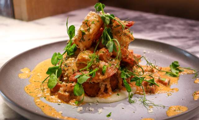 Plated dish with creamy toppings on top of it.