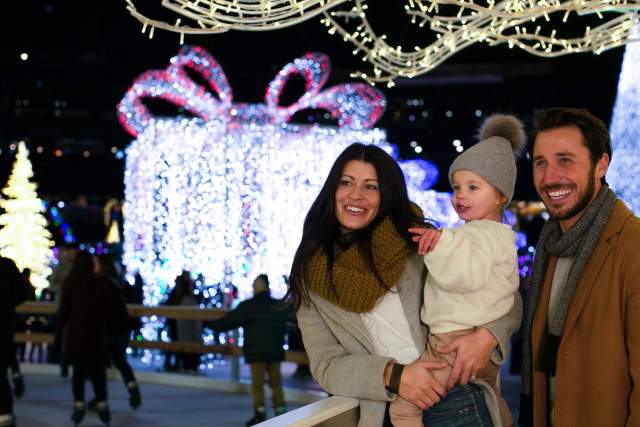 family enjoying Christmas lights