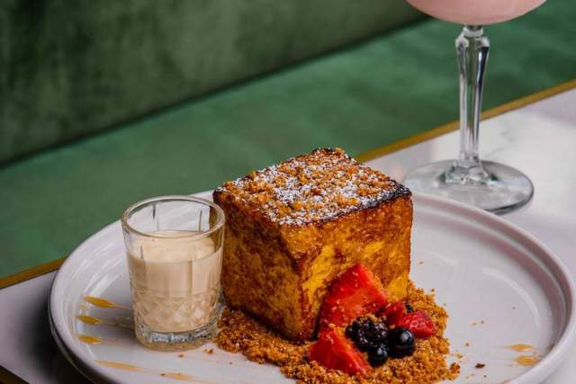 Pastry next to glass of sweet drink