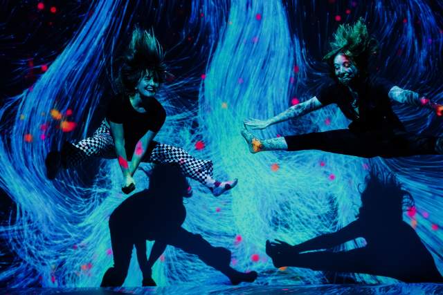 Two girls jumping in interactive museum