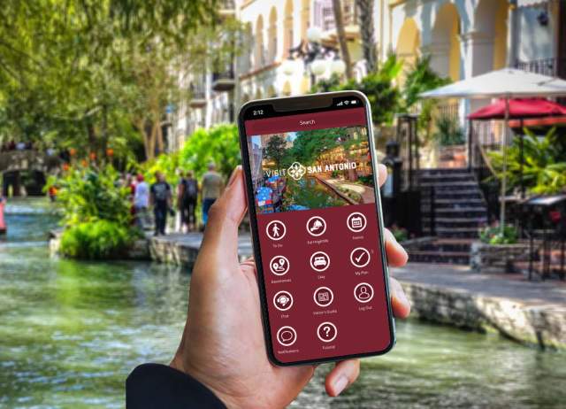 Hand holding a phone with the Visit San Antonio App