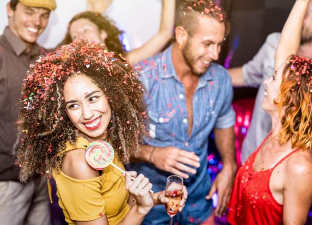 Multiracial happy friends having fun drinking wine