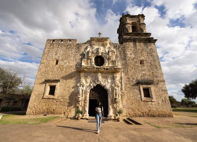Woman walking away from Mission San Jose