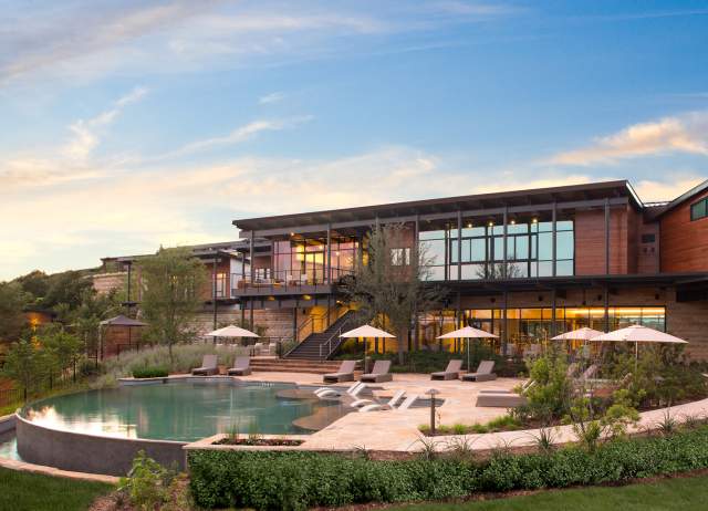 External building overlooking pool with umbrellas