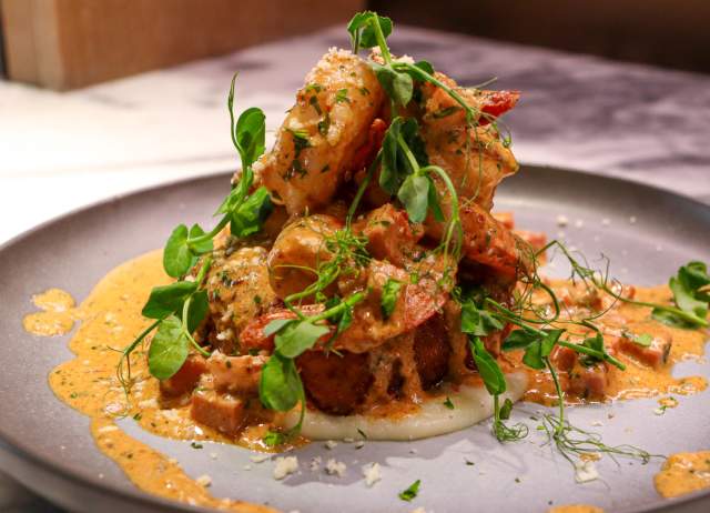 Plated dish with creamy toppings on top of it.