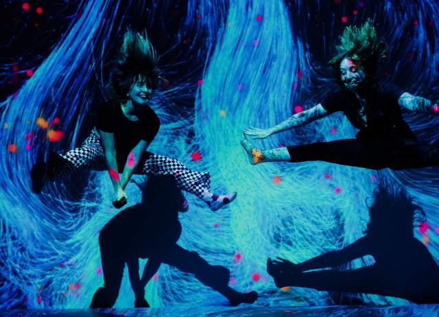 Two girls jumping in interactive museum