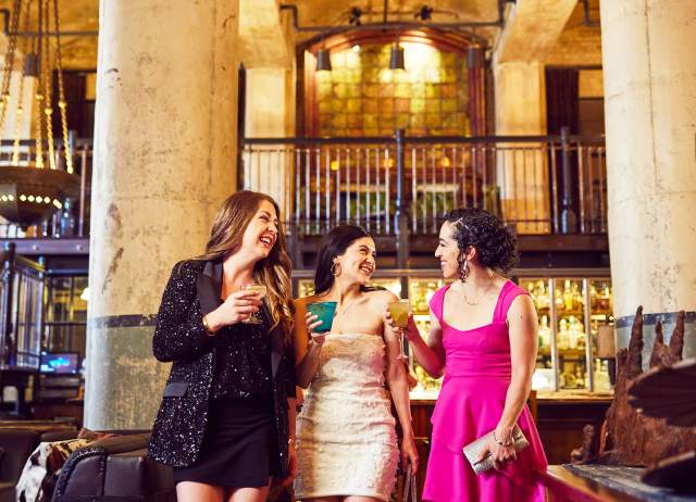 Three girls enjoying drinks in beautiful room with two large pillars at Sternewith.