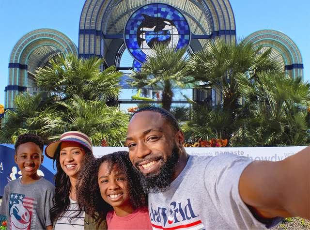 Family taking selfie in front of SeaWorld San Antonio arches