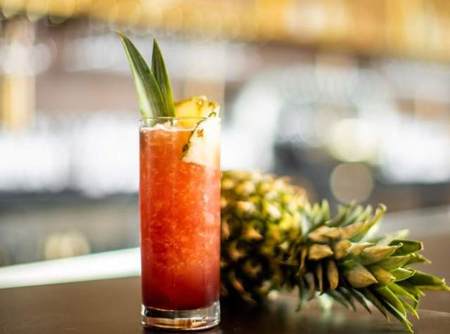 Adult beverage next to a pineapple