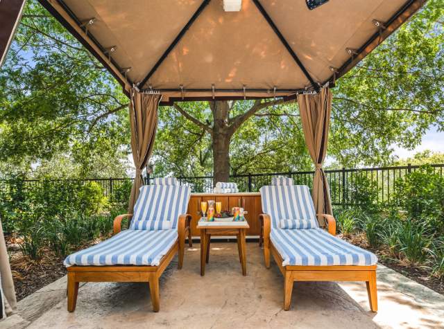 Two lounge chairs under a covered area