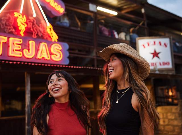 Two girls laughing at Tejas Rodeo in San Antonio