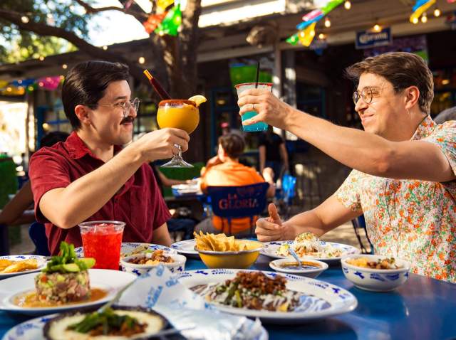 Couple enjoying frozen margaritas and mexican Food