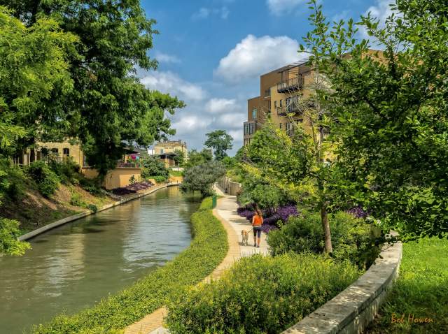 Woman walking dog along Museum Reach of River Walk