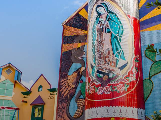 External view of Guadalupe Cultural Arts Center with veladora mural on side of building.