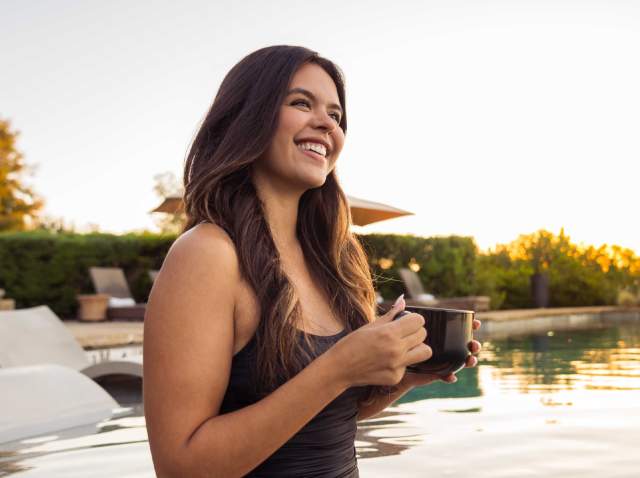 Woman drinking coffee at spa.