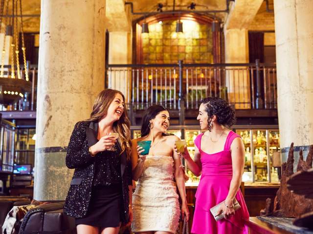 Three girls enjoying drinks in beautiful room with two large pillars at Sternewith.