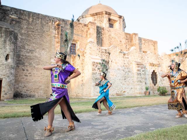 Performer smiling at San Antonio Missions National Historical Park.