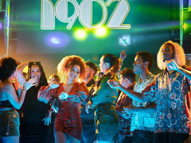 Group of people dancing at a nightclub.