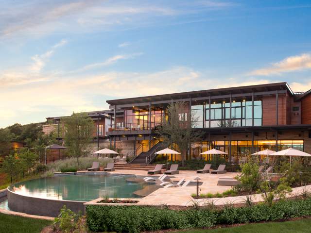 External building overlooking pool with umbrellas