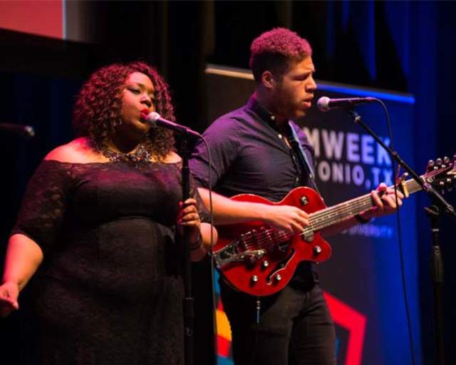Man playing guitar and woman singing