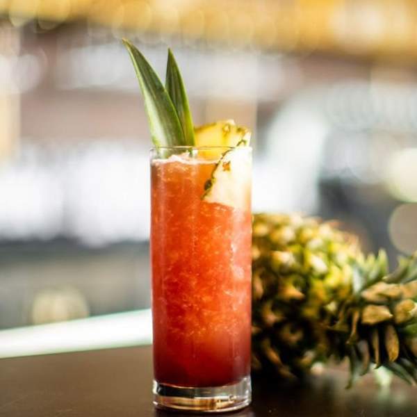 Adult beverage next to a pineapple