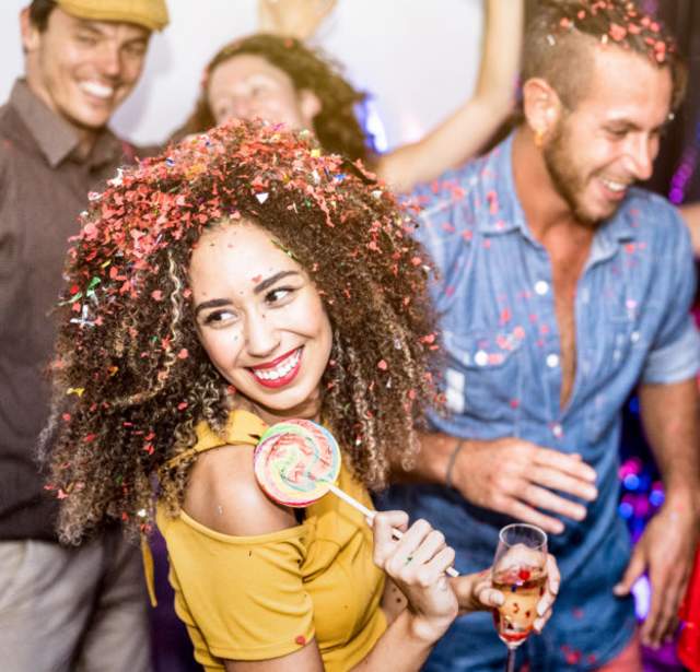 Multiracial happy friends having fun drinking wine