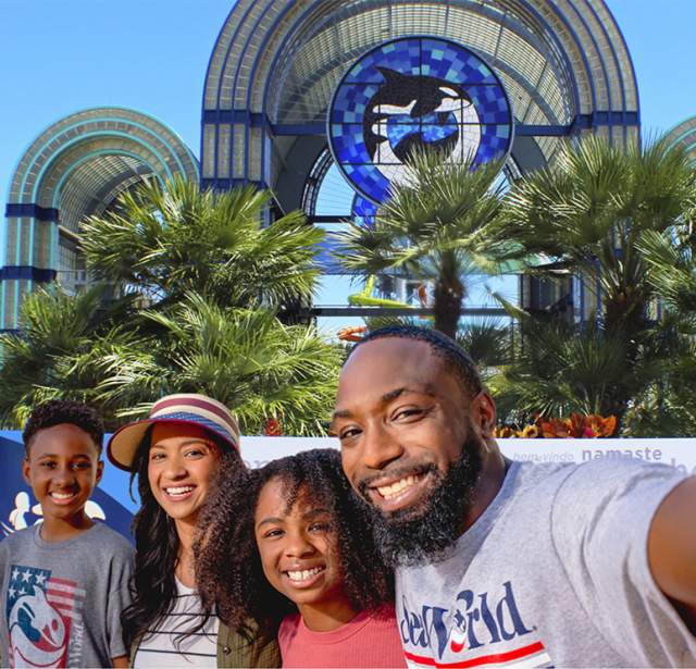 Family taking selfie in front of SeaWorld San Antonio arches
