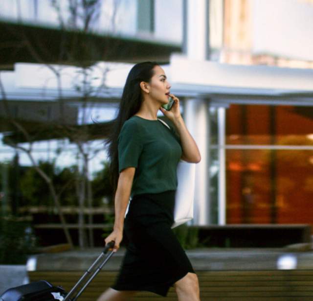 Woman walking and talking on phone
