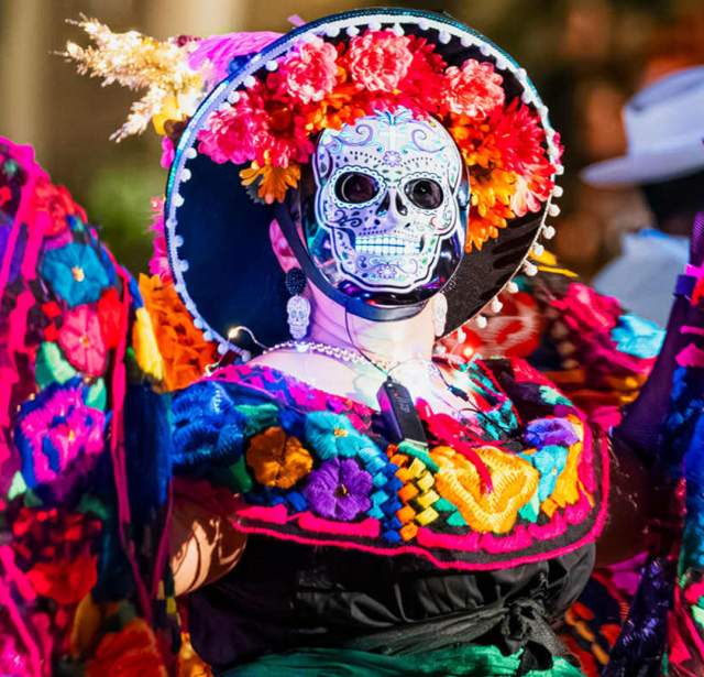 Performer in sugar skull mask at Day of the Dead event in San Antonio.