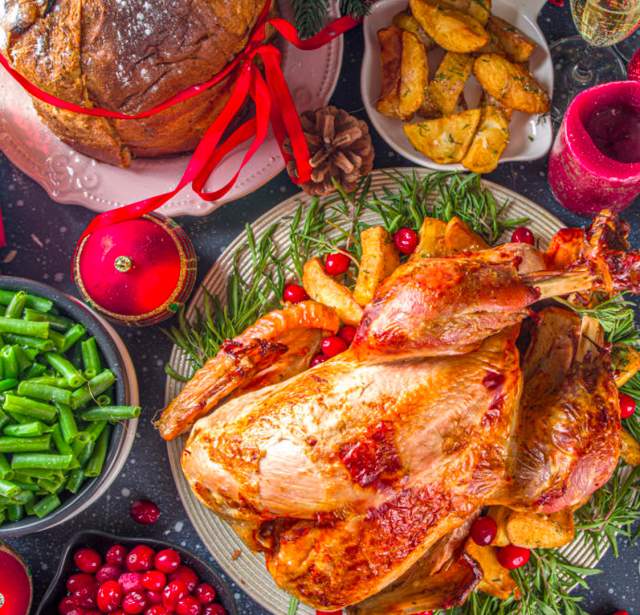Holiday turkey dinner surrounded by sides