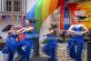 Dancers in blue uniform at Pride River Parade