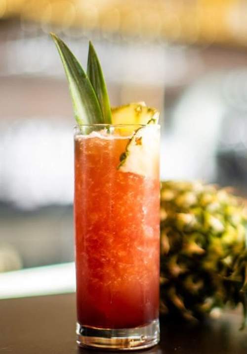 Adult beverage next to a pineapple